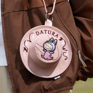 Pink round plush character blind box collectible with cute facial features and soft texture. Limited series POP MART designer toy.