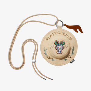 THE MONSTERS FALL IN WILD SERIES Bucket Hat Mini Bag featuring beige/cream monster character with hat design and lanyard attachment. Collectible blind box accessory combining cute character with functional mini storage pouch.