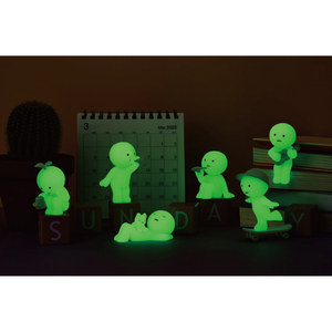SMISKI Sunday Series figures glowing in the dark, including various playful characters and a calendar.