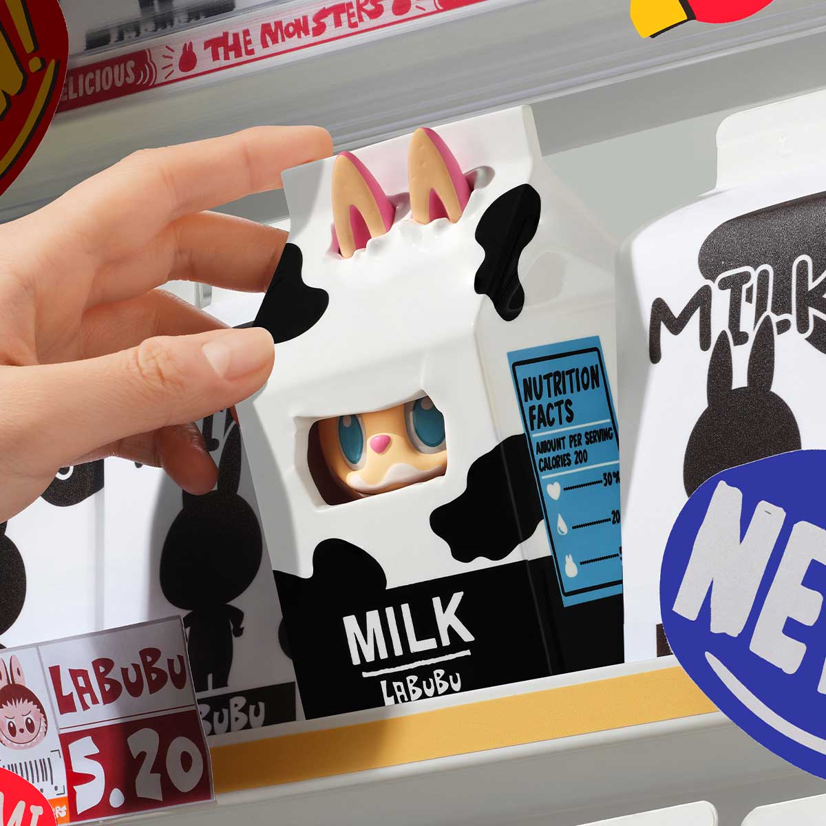 A hand holds a white and black Labubu milk carton figure with cow spots, displaying "MILK" and "LABUBU" text, positioned on store shelves.