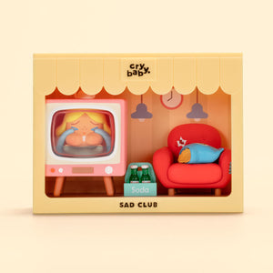 CRYBABY Sad Club Series yellow-themed kitchen diorama with detailed miniature appliances and emotional character interaction. Collectible scene set with domestic storytelling focus.