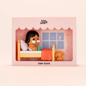 CRYBABY Sad Club Series pink-themed bedroom scene set with detailed miniature furniture and emotional character. Collectible diorama showcasing intimate storytelling moments.