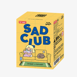 CRYBABY Sad Club Series blind box packaging with yellow design and series information. Official collectible mystery box featuring emotional diorama scene sets.